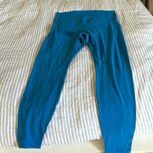 Two pairs of leggings. Light blue/grey is large and aqua blue is extra large.